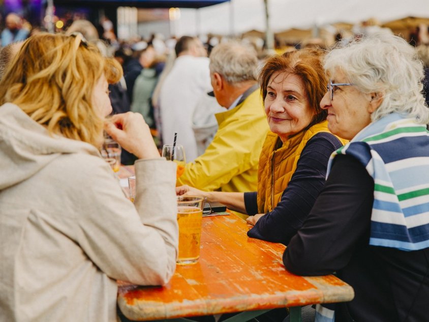 Menschen sitzen an einem Tisch und unterhalten sich