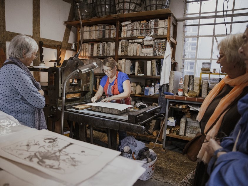 Das Bild zeigt eine Künstlerin in einer Druckwerkstatt während der Kunsttage 2024.